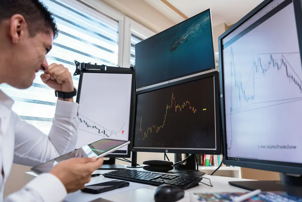 A trader reviewing backtest results and charts across multiple monitors