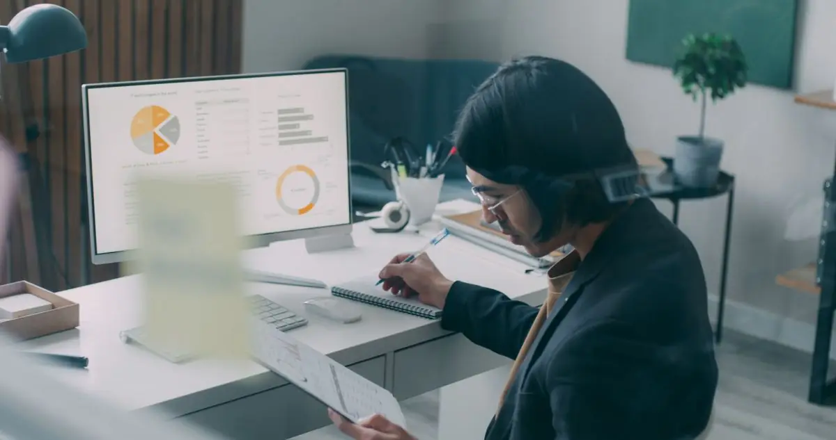 Trader comparing free trading journal software analytics at a desk