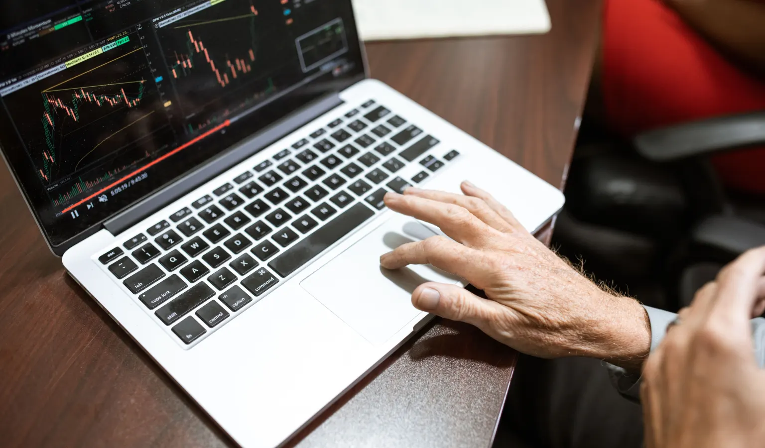 Trader reviewing a candlestick chart on a laptop before starting a backtest session
