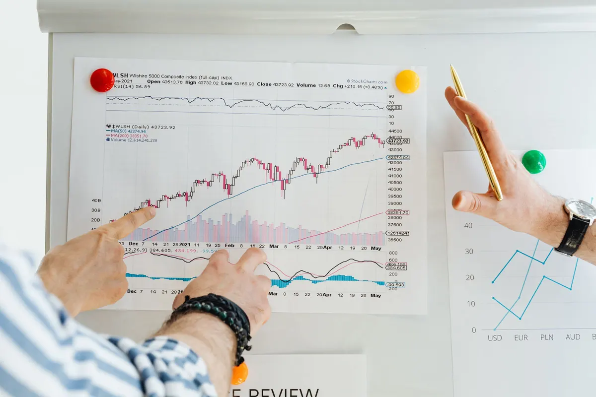 Two traders comparing strategy performance charts side by side